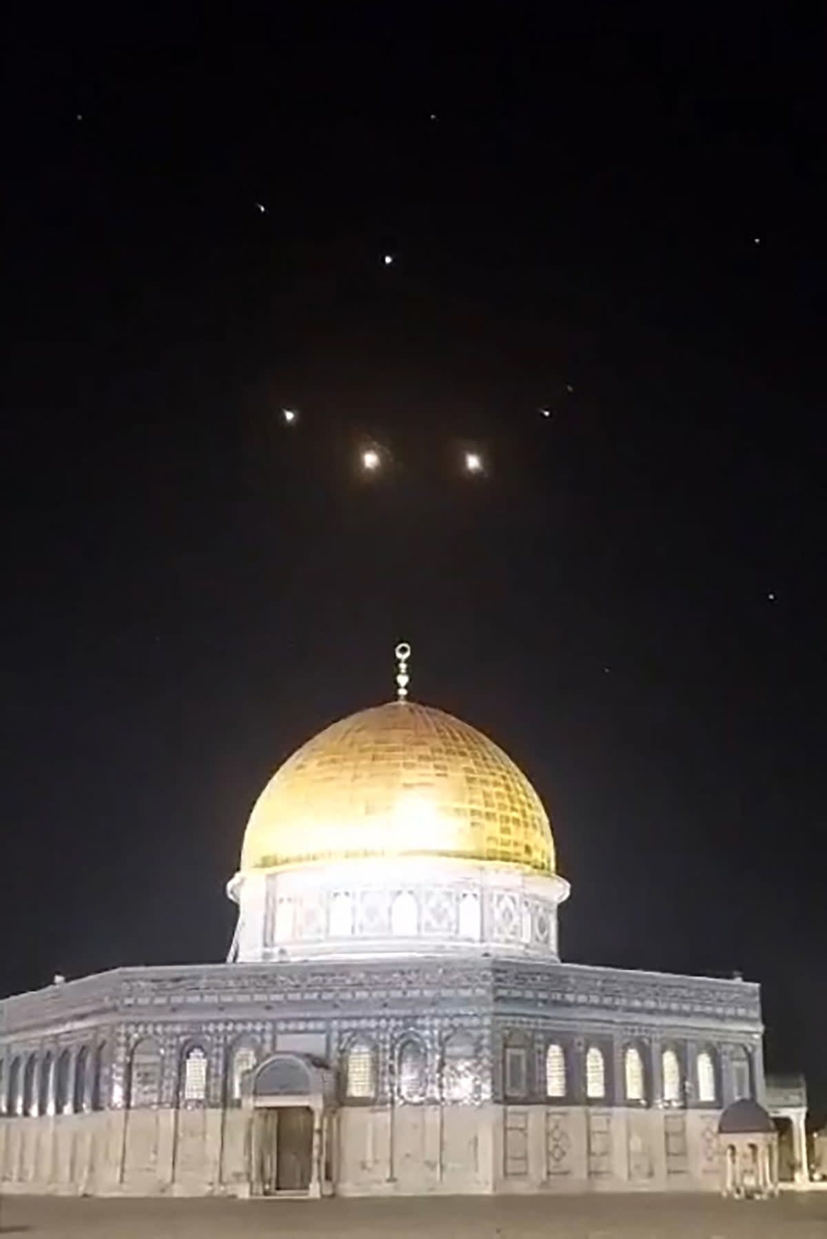 An image-grab from a video taken early on April 14, 2024, shows rocket trails in the sky above the Al-Aqsa Mosque compound in Jerusalem. (AFP via Getty Images)