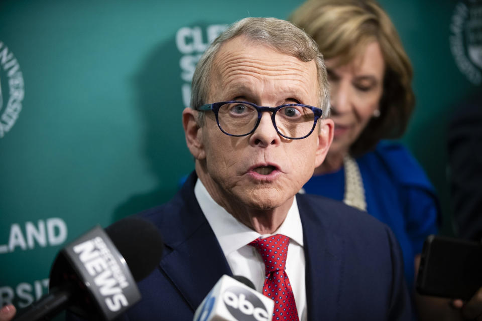 FILE - In this Oct. 8, 2018, file photo, Ohio Attorney General and Republican gubernatorial candidate Mike DeWine answers questions from the media in the spin room following a debate with Democratic gubernatorial candidate Richard Cordray at Cleveland State University, in Cleveland. Locked in a tight race for governor in the perennial swing state of Ohio, DeWine and Cordray are using the final stretch to hedge their bets on Donald Trump. (AP Photo/Angelo Merendino, File)