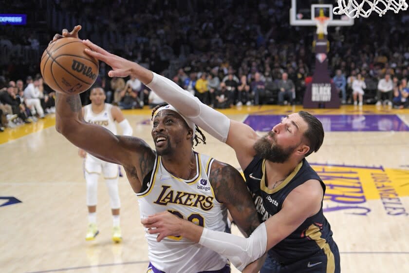 Los Angeles Lakers center Dwight Howard, left, and New Orleans Pelicans center Jonas Valanciunas battle for a rebound.