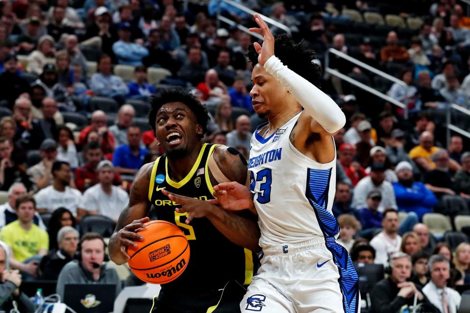 Oregon Ducks guard Jermaine Couisnard (5) drives to the basket against Creighton Bluejays guard Trey Alexander (23) during the second half in the second round of the 2024 NCAA Tournament at PPG Paints Arena March 23, 2024, in Pittsburgh, Pennsylvania.