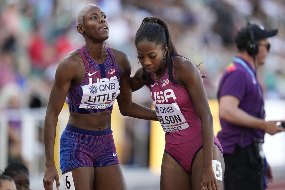 Shamier Little, of the United States, left, speaks with Britton Wilson, of the United States, after a heat in the women's 400-meter hurdles at the World Athletics Championships on Wednesday, July 20, 2022, in Eugene, Ore. (AP Photo/Ashley Landis)