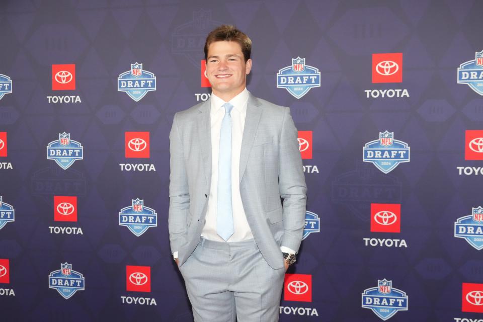 North Carolina Tar Heels quarterback Drake Maye (right) stands on the red carpet ahead of the 2024 NFL Draft at Detroit’s Fox Theatre.