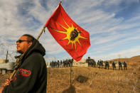 <p>A protesters flies a flag during a stand off with police during a protest against the Dakota Access pipeline near the Standing Rock Indian Reservation near Cannon Ball, North Dakota November 6, 2016. (Photo: Stephanie Keith/Reuters) </p>