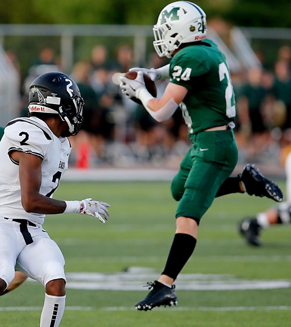 Mason High School safety Weston Simmons intercepts a pass meant for Lakota East receiver Caleb Vanhosser during a GMC conference football game at Mason Sept. 17, 2021.