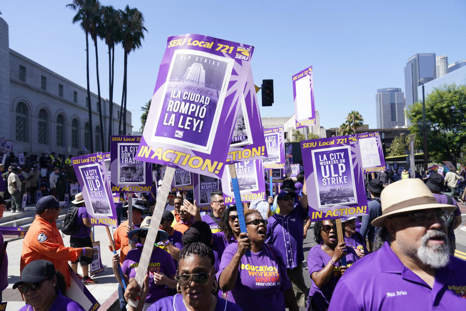 Workers picket outside of City Hall, Tuesday, Aug. 8, 2023, in Los Angeles. Thousands of Los Angeles city employees, including sanitation workers, lifeguards and traffic officers, walked off the job Tuesday for a 24-hour strike alleging unfair labor practices. (AP Photo/Ryan Sun)