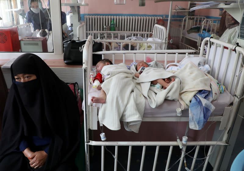 FILE PHOTO: Newborn children who lost their mothers during the yesterday's attack lie on a bed at a hospital, in Kabul