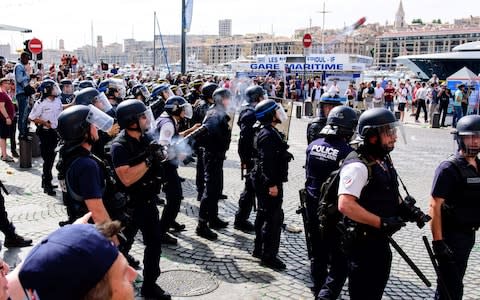 This file photo taken on June 11, 2016 shows a French riot policeman firing tear gas during fights between supporters of England, Russia and French groups in Marseille, on the sidelines of the Euro 2016 European football championships. A Russian football hooligan sought by authorities for savagely attacking a British fan at Euro 2016 in France has been arrested, German police said on February 22, 2018 - Credit: AFP
