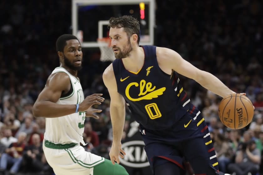 FILE - In this March 4, 2020, file photo, Cleveland Cavaliers' Kevin Love (0) drives against the Boston Celtics during an NBA basketball game in Cleveland. The teams that didn't qualify for the restart of the NBA season at Walt Disney World could begin voluntary workouts Wednesday, Sept. 23, to start preparing for their next game — whenever that is. Love said it was "paramount" for the team to get together and make up for lost time. (AP Photo/Tony Dejak, File)