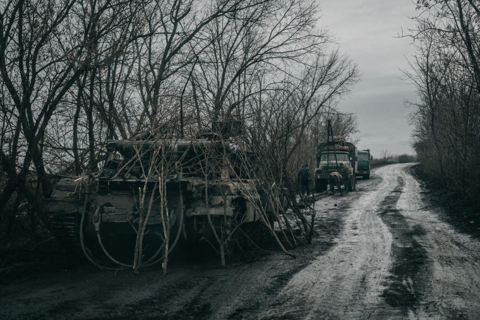 A damaged Ukrainian tank is hidden on a road near the village of Novoselivka Persha on the outskirts of Avdiivka, Ukraine, on Feb. 3, 2024. (Wojciech Grzedzinski/For The Washington Post via Getty Images)