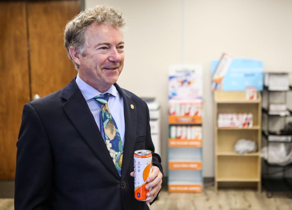 Sen. Rand Paul has a Phocus sparkling water energy drink as part of his visit to the Louisville company on Dec. 6, 2021.