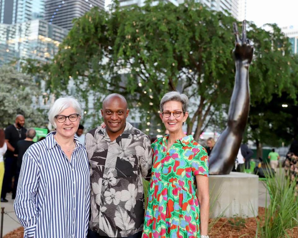 (De izquierda a derecha) Victoria Rogers, vicepresidenta de Artes de la Knight Foundation; el artista conceptual Hank Willis Thomas, y Meg Daly, creadora de The Underline, en la inauguración de "Duality" en su sede permanente en The Underline. La escultura de Thomas refleja cómo un mismo símbolo puede interpretarse de distintas maneras.