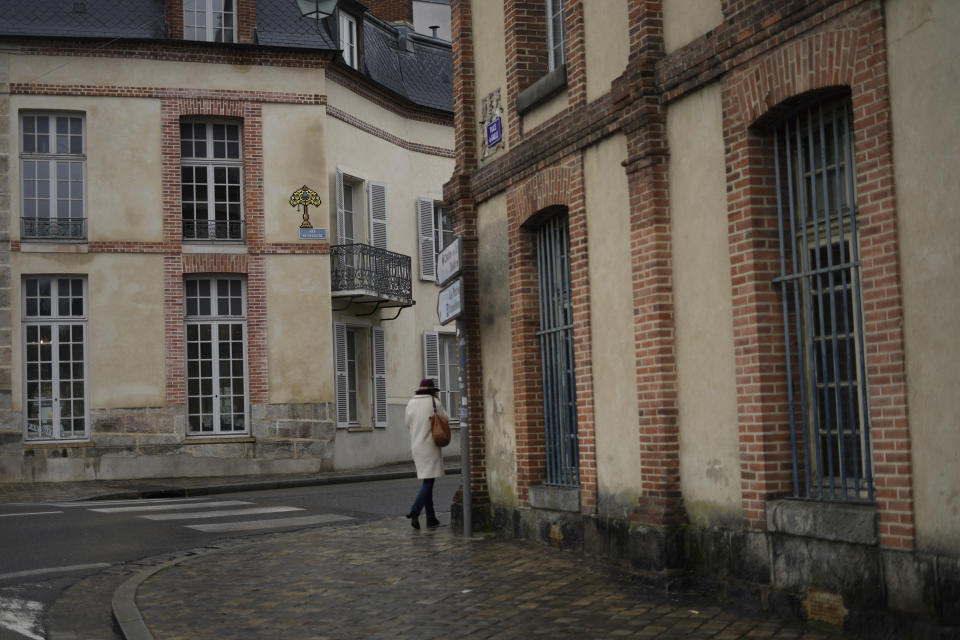 A mosaic by French artist Invader, top center, is seen on a street of Fontainebleau, south of Paris, Thursday, Feb. 29, 2024. For the Paris Olympics, it could almost have been a new sport: Score points by scouring France's capital for mosaics that a mystery artist who calls himself "Invader" has cemented to walls across the city, across the world and even had carried aloft to the International Space Station. (AP Photo/Thibault Camus)