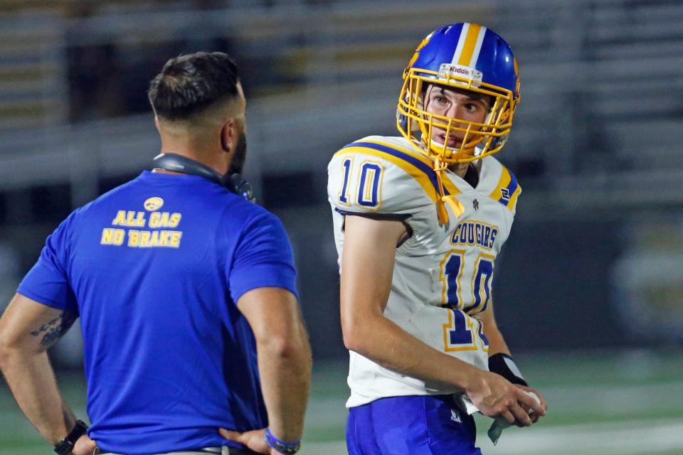 North Providence QB Ben Borkman, shown speaking to his coach during a September game, threw for 68 yards and a touchdown on Saturday against EWG-Prout.