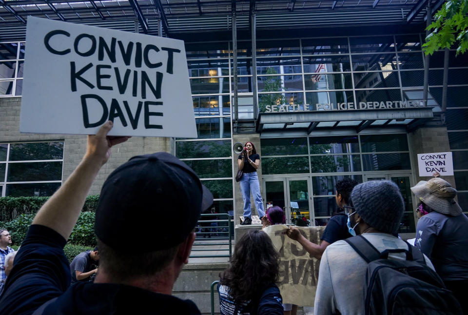FILE - Kyla Carrillo, center, leads a chant on the steps of the Seattle Police Department's West Precinct as people protest after body camera footage was released of a Seattle police officer joking about the death of Jaahnavi Kandula, a 23-year-old woman hit and killed in January by officer Kevin Dave in a police cruiser, Thursday, Sept. 14, 2023, in Seattle. Prosecutors in Washington state said Wednesday, Feb. 21, 2024, they will not file felony charges against Seattle police officer, Dave, who struck and killed the graduate student from India while responding to an overdose call.. (AP Photo/Lindsey Wasson, File)