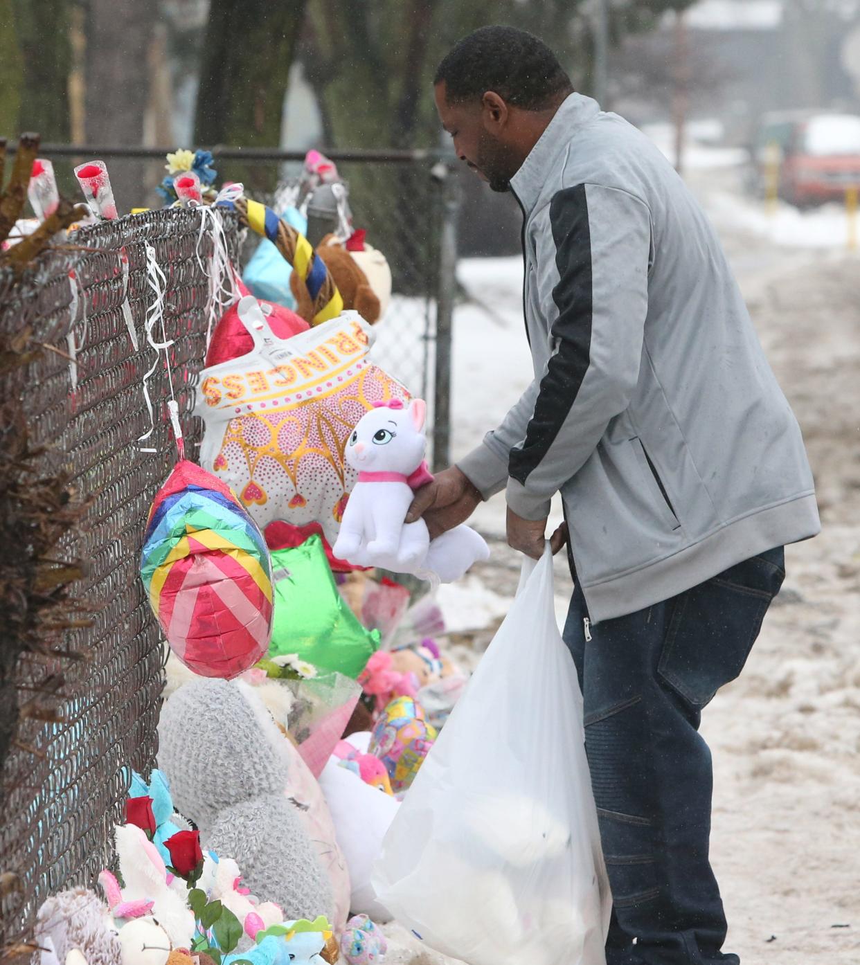 Walter Smith puts one of five stuffed animals outside the house at 222 N. LaPorte Ave. on Wednesday, Jan. 24, 2024, after Sunday’s fire where five children died inside the home. He and Doris Smith said they wanted to put five in memory of the five children.