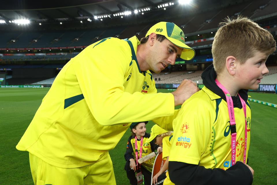 Pat Cummins, pictured here signing an autograph for a young fan after the third ODI at the MCG.