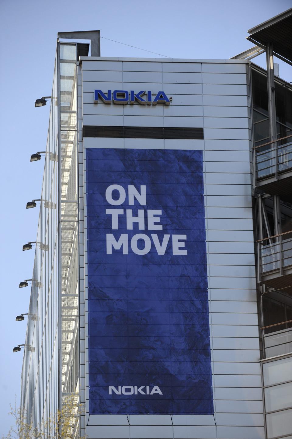 The Nokia headquarters building in Keilaniemi, Espoo, Finland, displays a banner saying they are moving Friday April 25, 2014. Nokia headquarters are "On the move" to join Nokia Solutions and Networks' headquarters in Karakallio, Espoo. Nokia said Friday it has completed the 5.44 billion-euro ($7.5 billion) sale of its troubled cellphone and services division to Microsoft Corp., ending a chapter in the former world leading cellphone maker's history that began with paper making in 1865. The closure of the deal, which includes a license to a portfolio of Nokia patents to Microsoft Corp., follows delays in global regulatory approvals, and ends the production of mobile phones by the Finnish company, which had led the field for more than a decade, peaking with a 40-percent global market share in 2008. (AP Photo/Lehtikuva, Mikko Stig) FINLAND OUT