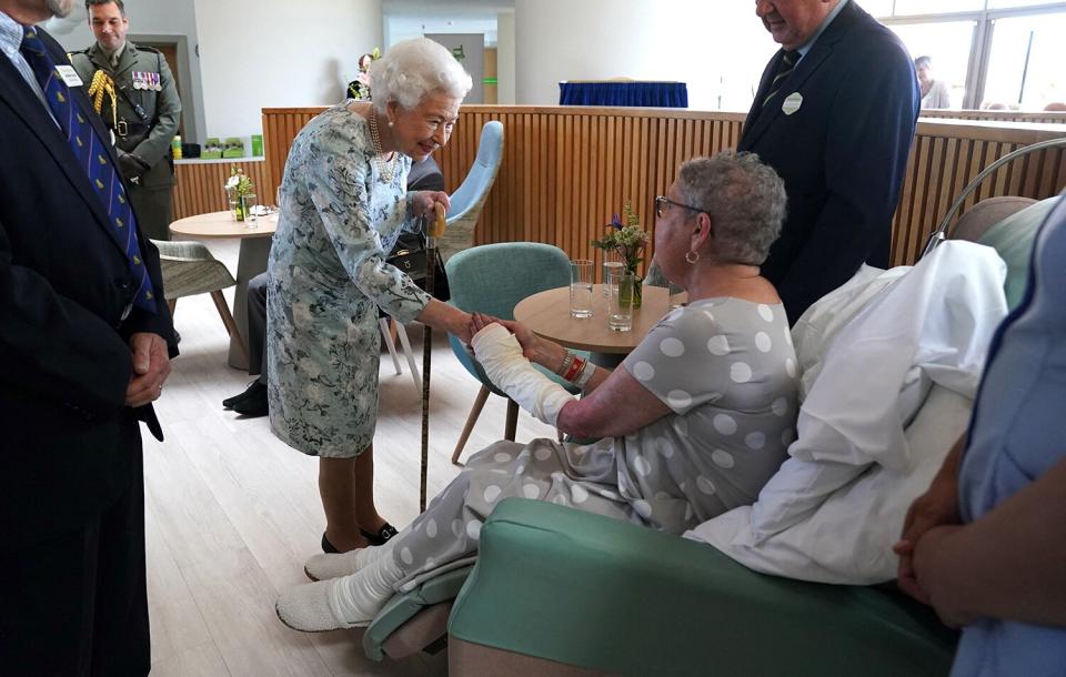 Britain's Queen Elizabeth II shakes hands with patient Pat White during a visit to officially open the new building of Thames Hospice in Maidenhead, Berkshire