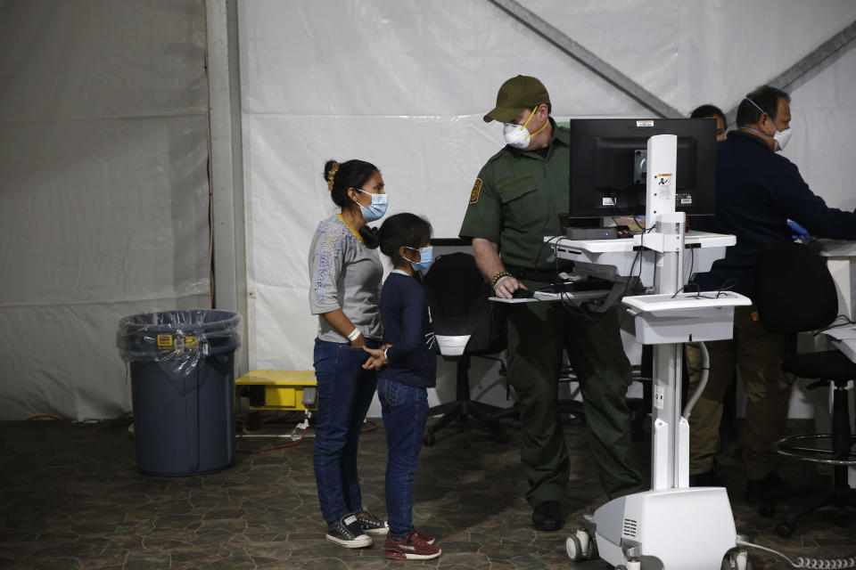 A migrant and her daughter have their biometric data entered at the intake area in the Department of Homeland Security holding facility on March 30, 2021 in Donna, Texas. / Credit: Dario Lopez-Mills / Getty Images