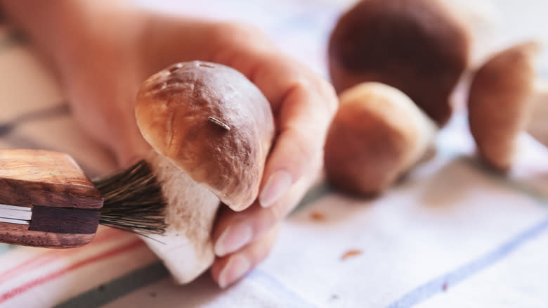 cleaning mushrooms with a brush