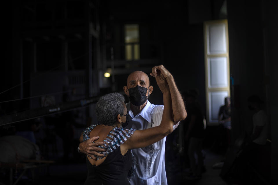 Joaquin Bruzon and his wife Milagros Cousett dance during a rehearsal for the Failde orchestra's Danzon music in Matanzas, Cuba, Saturday, Oct. 2, 2021. The couple said it was very hard to be for a year and a half without being able to go out to the recreation centers to dance. Sometimes during the quarantine at home we would dance to try to improve our spirits. (AP Photo/Ramon Espinosa)