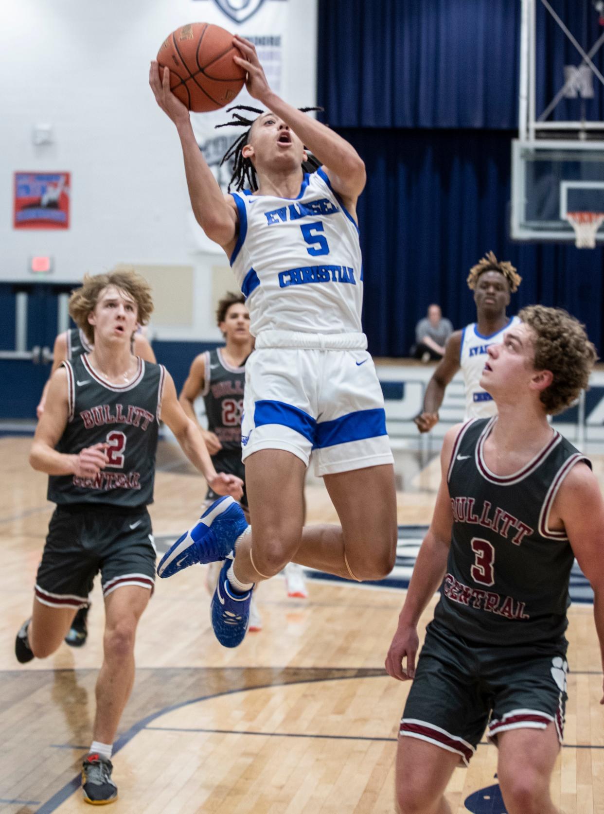 Evangel Christian's Kyran Tilley shoots over Bullitt Central defenders n the boys 23rd district basketball final. Feb. 25, 2022