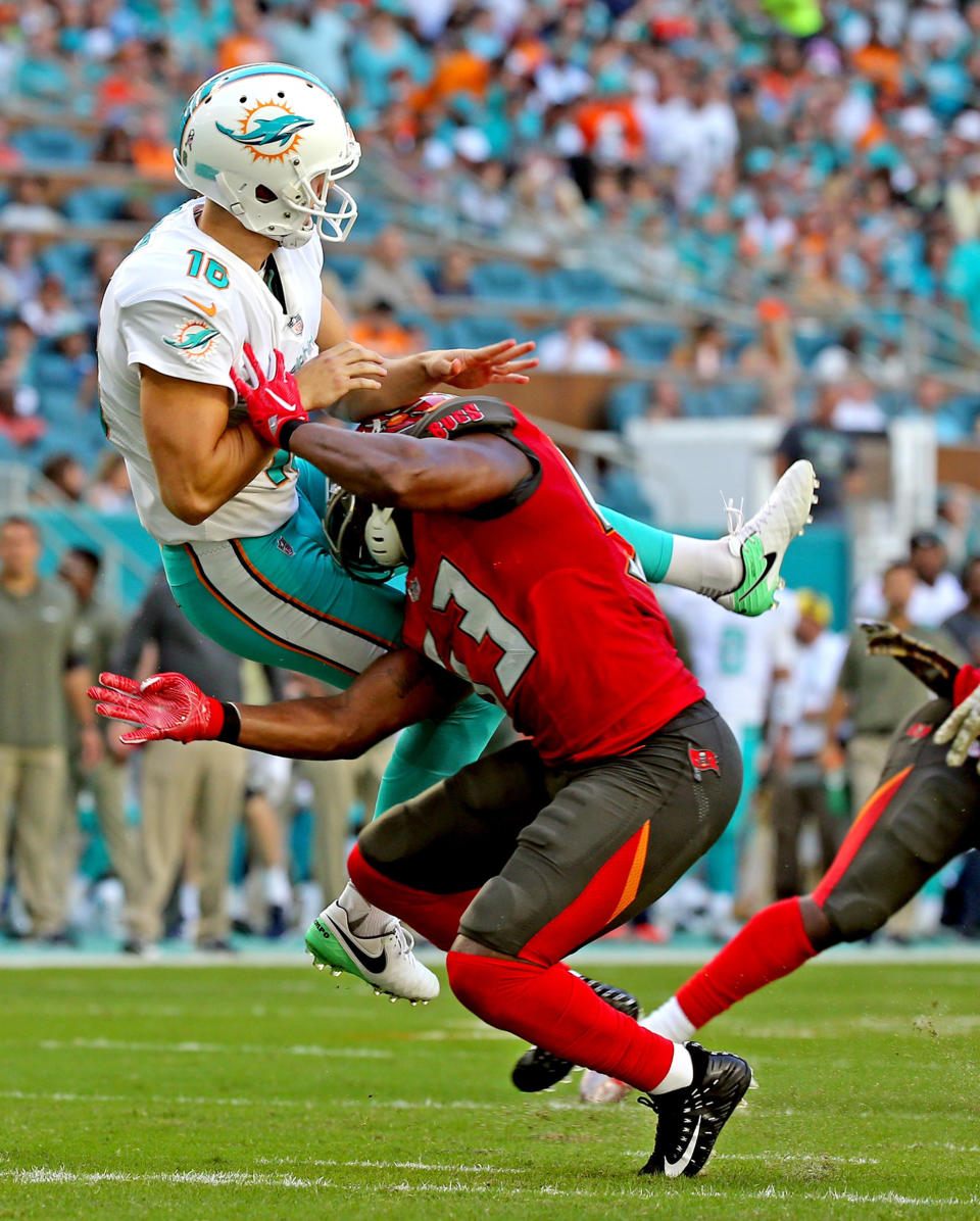 <p>Miami Dolphins kicker Matt Haack (16) is hit by Tampa Bay Buccaneers’ Adarius Glanton (53) on Sunday, Nov. 19, 2017 at Hard Rock Stadium in Miami Gardens, Fla. (Charles Trainor Jr./Miami Herald/TNS) </p>