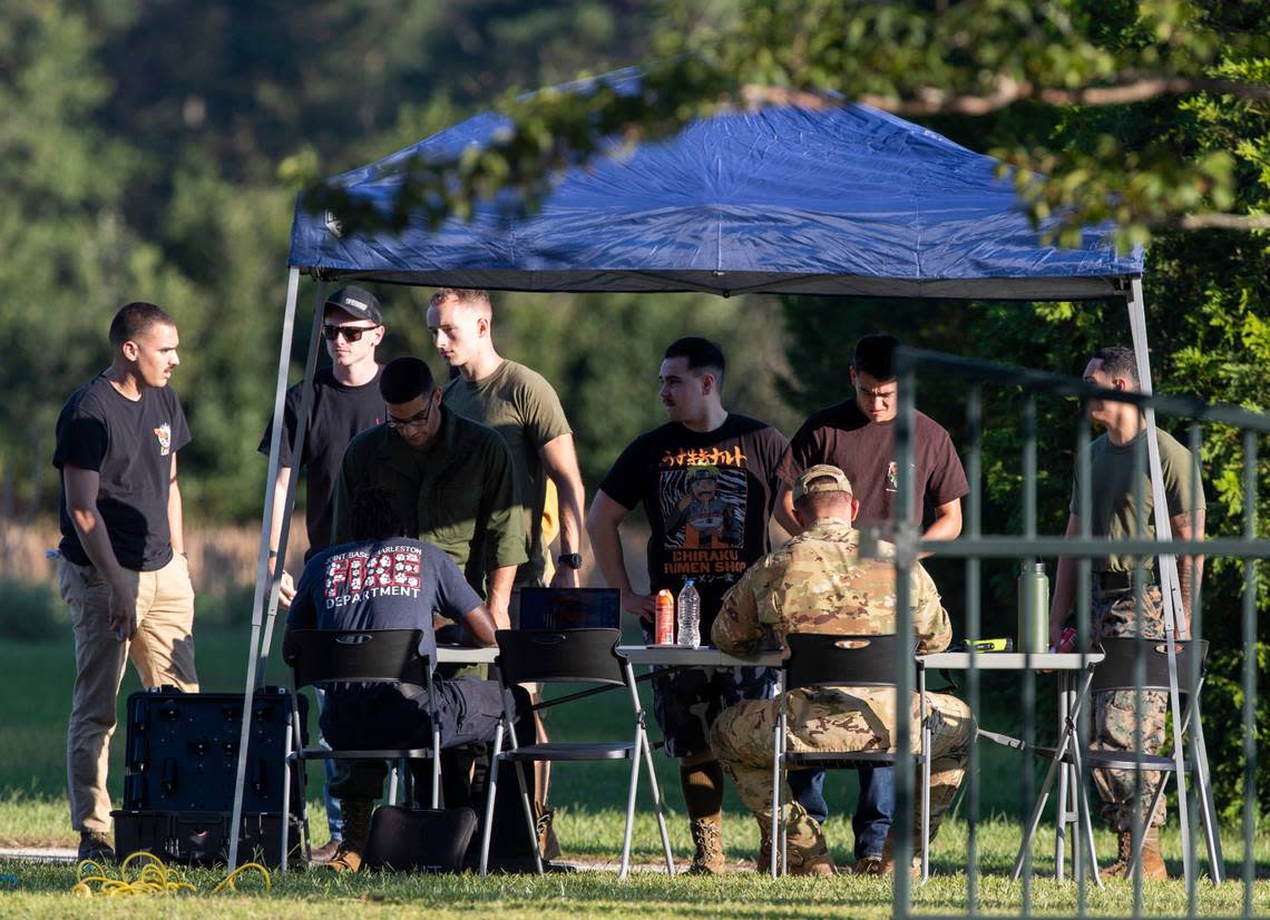 Local law enforcement and airmen from Joint Base Charleston set up a tent and tables to begin coordinating recovery efforts for a stealth fighter jet that crashed in Williamsburg County, S.C., on Monday, Sept. 18, 2023. (Henry Taylor/The Post And Courier via AP)