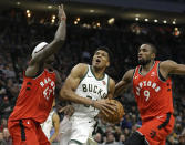 Milwaukee Bucks' Giannis Antetokounmpo, middle, drives to the basket between Toronto Raptors' Pascal Siakam (43) and Serge Ibaka (9) during the second half of an NBA basketball game, Saturday, Jan. 5, 2019, in Milwaukee. The Raptors won 123-116. (AP Photo/Aaron Gash)