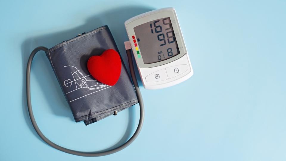 A blood pressure cuff with a red heart on a blue background