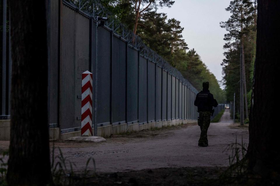 A border guard patrol along the border wall at the Polish - Belarus border not far from Bialowieza, eastern Poland, on May 29, 2023. (WOJTEK RADWANSKI/AFP via Getty Images)