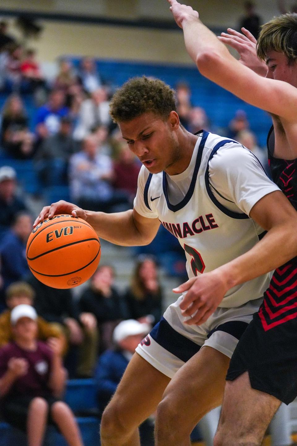 Pinnacle's Duce Robinson (2), left, drives to the basket while guarded by Liberty's Trevor Owens (24), right, dribbles the ball up the court during the first half against Liberty High School at Pinnacle High School on Thursday, Feb. 17, 2022, in Phoenix.