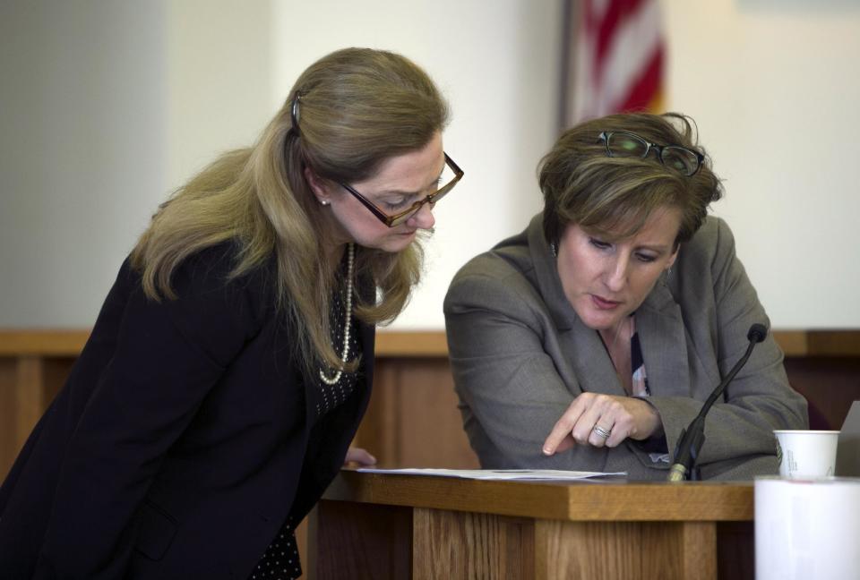 Attorney Jaye Rancourt, right, looks over copies of emails between St. Paul School students with Deputy Merrimack County Attorney Catherine Ruffle, left, at Merrimack County Superior Court in Concord, N.H., during an evidentiary hearing on whether Owen Labrie should be granted a retrial. Labrie, a prep school graduate convicted of using a computer to lure an underage girl for sex, returned to court for a hearing on whether his lawyers damaged his case. (Geoff Forester/The Concord Monitor via AP, Pool)