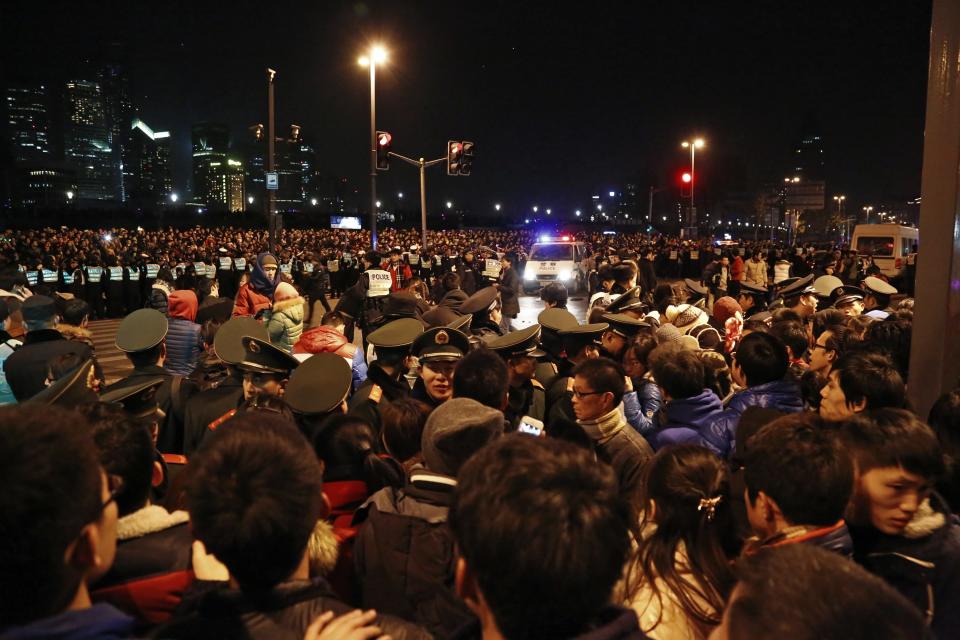 Police control the site after a stampede occurred during a New Year's celebration on the Bund, central Shanghai