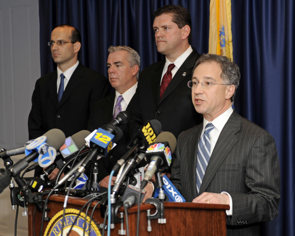 U.S. Attorney Paul J.Fishman, right, speaks at at a news conference announcing the uncovering of one of the largest counterfeit goods smuggling operations ever charged Friday, March 2, 2012, in Newark, N.J. (AP Photo/Bill Kostroun)