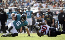 <p>Jacksonville Jaguars quarterback Cody Kessler (6) is sacked by Houston Texans linebacker Jadeveon Clowney (90) during the second half of an NFL football game, Sunday, Oct. 21, 2018, in Jacksonville, Fla. (AP Photo/Phelan M. Ebenhack) </p>