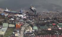 An aerial view shows ships washed ashore into a coastal community after Typhoon Haiyan hit the province of Leyte central Philippines November 10, 2013. One of the most powerful storms ever recorded killed at least 10,000 people in the central Philippines, a senior police official said on Sunday, with huge waves sweeping away coastal villages and devastating one of the main cities in the region. REUTERS/Ryan Lim/Malacanang Photo Bureau/Handout via Reuters (PHILIPPINES - Tags: ENVIRONMENT DISASTER MARITIME TPX IMAGES OF THE DAY) ATTENTION EDITORS - THIS IMAGE WAS PROVIDED BY A THIRD PARTY. FOR EDITORIAL USE ONLY. NOT FOR SALE FOR MARKETING OR ADVERTISING CAMPAIGNS. NO SALES. NO ARCHIVES. THIS PICTURE IS DISTRIBUTED EXACTLY AS RECEIVED BY REUTERS, AS A SERVICE TO CLIENTS