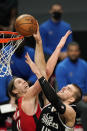 Los Angeles Clippers center Ivica Zubac, right, shoots as Houston Rockets forward Kelly Olynyk defends during the first half of an NBA basketball game Friday, April 9, 2021, in Los Angeles. (AP Photo/Mark J. Terrill)