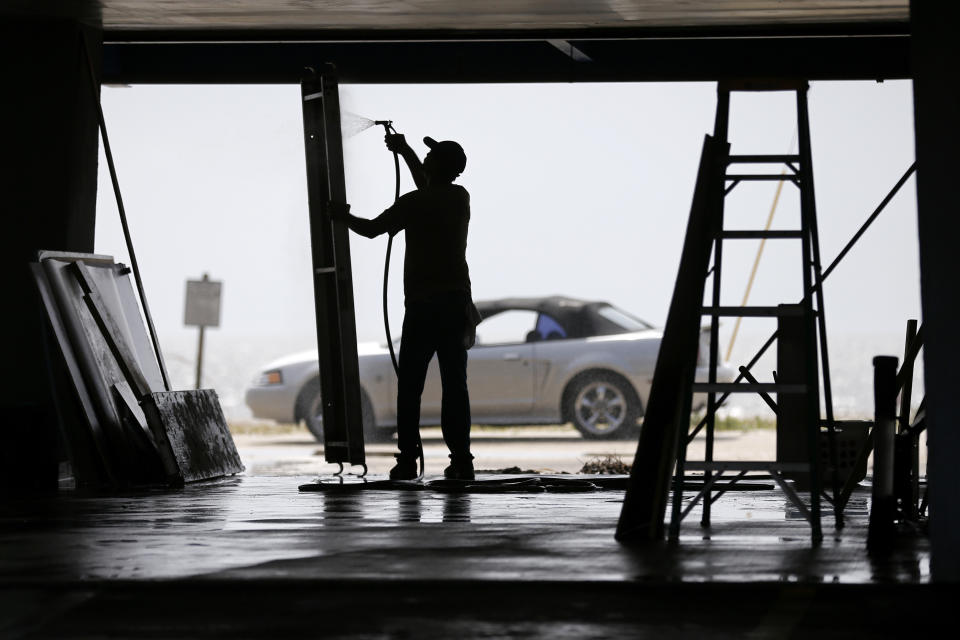 <p>A man washes shutters damaged by Hurricane Nate in Biloxi, Mississippi, U.S. October 8, 2017. (Photo: Jonathan Bachman/Reuters) </p>