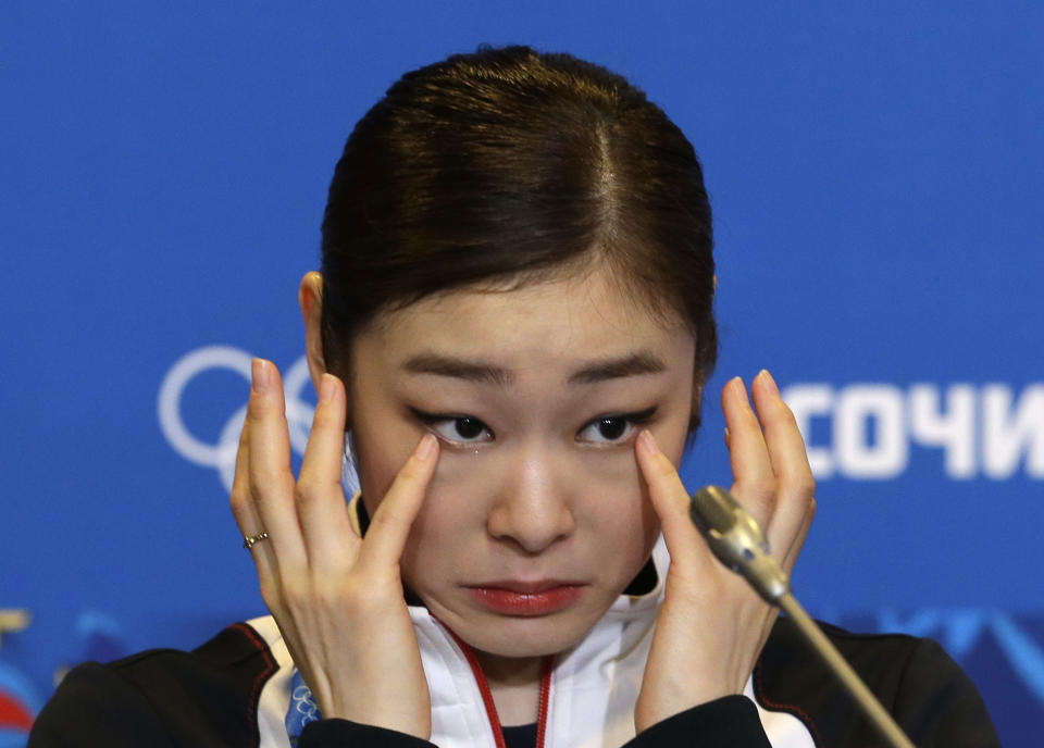 Yuna Kim of South Korea wipes her face as she attends a news conference following the women's free skate figure skating finals at the Iceberg Skating Palace during the 2014 Winter Olympics, Thursday, Feb. 20, 2014, in Sochi, Russia. (AP Photo/Darron Cummings)