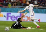 France's Karim Benzema, right, kicks the ball past Portugal's goalkeeper Rui Patricio to score his team's second goal during the Euro 2020 soccer championship group F match between Portugal and France at the Puskas Arena, Budapest, Hungary, Wednesday, June 23, 2021. (AP Photo/Darko Bandic,Pool)