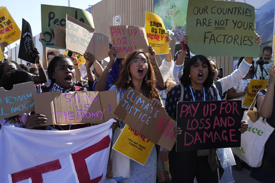 Mitzi Jonelle Tan, of the Philippines, center, takes part in a Fridays for Future protest calling for money for climate action at the COP27 U.N. Climate Summit, Friday, Nov. 11, 2022, in Sharm el-Sheikh, Egypt.