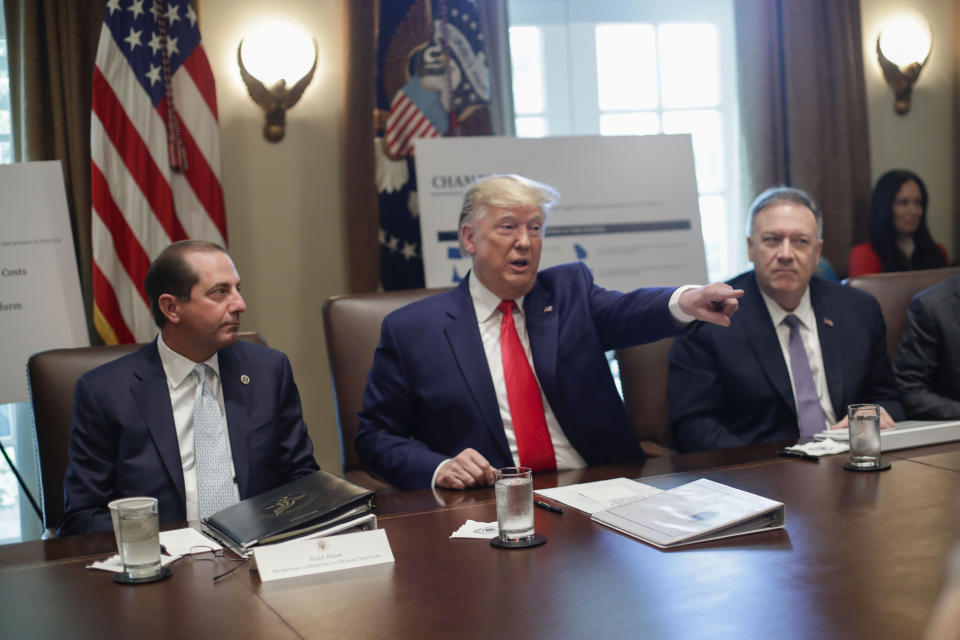 President Donald Trump, center, points to members of his Cabinet while speaking during a Cabinet meeting in the Cabinet Room of the White House, Monday, Oct. 21, 2019, in Washington, as Health and Human Services Secretary Alex Azar, left, and Secretary of State Mike Pompeo, right, listen. (AP Photo/Pablo Martinez Monsivais)