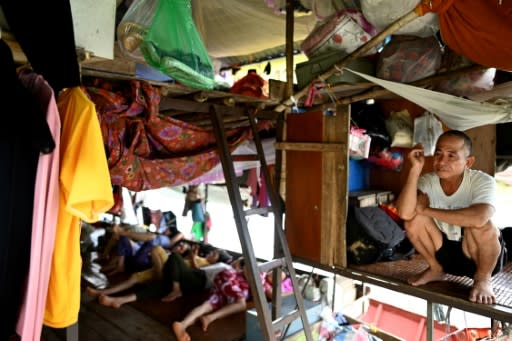 Vietnamese migrant workers living on Hanoi's Red River rise before dawn to buy fruit wholesale before heading to a market