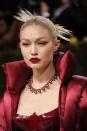 <p>Gigi Hadid's red carpet look at this year's Met Gala bought all the drama. Her jewellery was no different, as the model and mother matched her statement-making Versace latex catsuit and floor-length puffer coat with a beaded burgundy necklace by Chopard and a complementing red lip. </p>