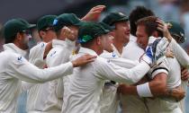 Australia's Ryan Harris (R) celebrates with teammates after taking the catch to dismiss England's captain Alastair Cook during the fourth day's play in the second Ashes cricket test at the Adelaide Oval December 8, 2013.