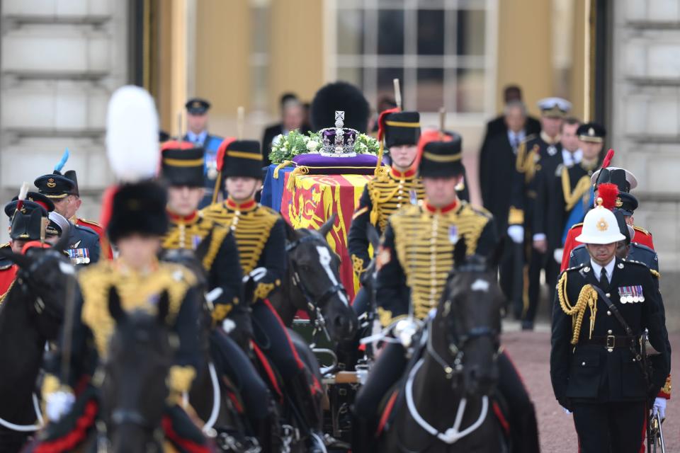 The coffin of Queen Elizabeth II, draped in the Royal Standard with the Imperial State Crown placed on top, is carried on a horse-drawn gun carriage of the King's Troop Royal Horse Artillery (PA)