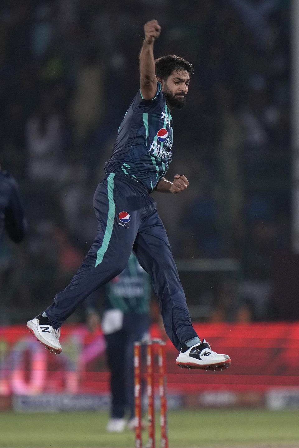 Pakistan's Harif Rauf, center, jumps to celebrate after taking the wicket of England's Olly Stone during the fourth twenty20 cricket match between Pakistan and England, in Karachi, Pakistan, Sunday, Sept. 25, 2022. (AP Photo/Anjum Naveed)