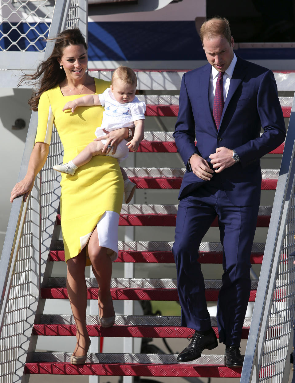 Britain's Prince William with his wife Kate, Duchess of Cambridge, and Prince George, arrives in Sydney Wednesday, April 16, 2014. The royal couple are on a three-week tour of Australia and New Zealand, the first official trip overseas with their son, Prince George. (AP Photo/Rob Griffith)