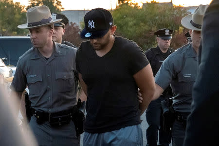 Nauman Hussain (C), the operator of a limousine company that owned the vehicle involved in a crash that killed 20 people in upstate New York arrives for his arraignment at Cobleskill Town Court in Cobleskill, New York, U.S., October 10, 2018. REUTERS/Cindy Schultz 